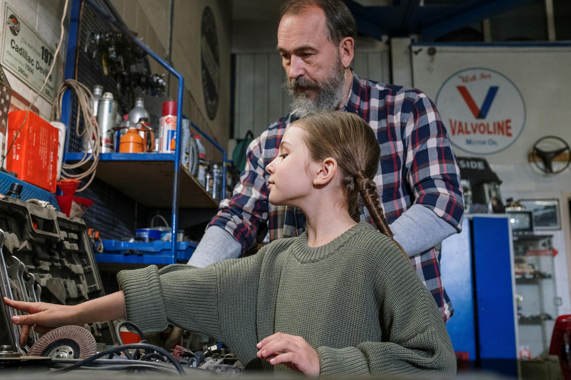 A Man and his Daughter Looking at Tools in a Garage